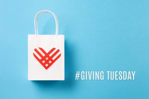 Giving Tuesday, global day of charitable giving after Black Friday shopping day. Charity, give help, donations support concept. Red paper heart and shopping bag on blue background. Top view, copy space, flat lay.